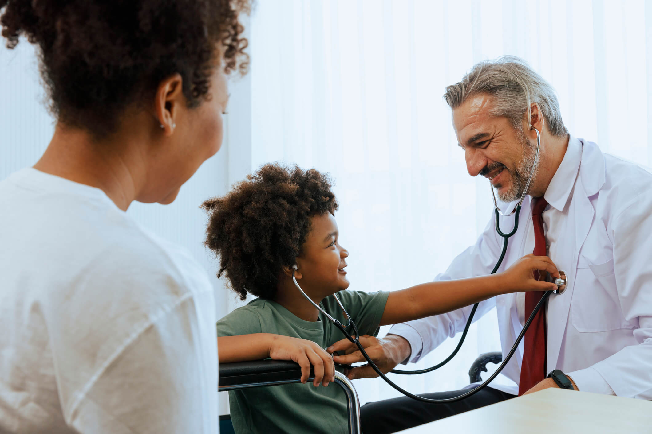 doctor showing a child a stethoscope