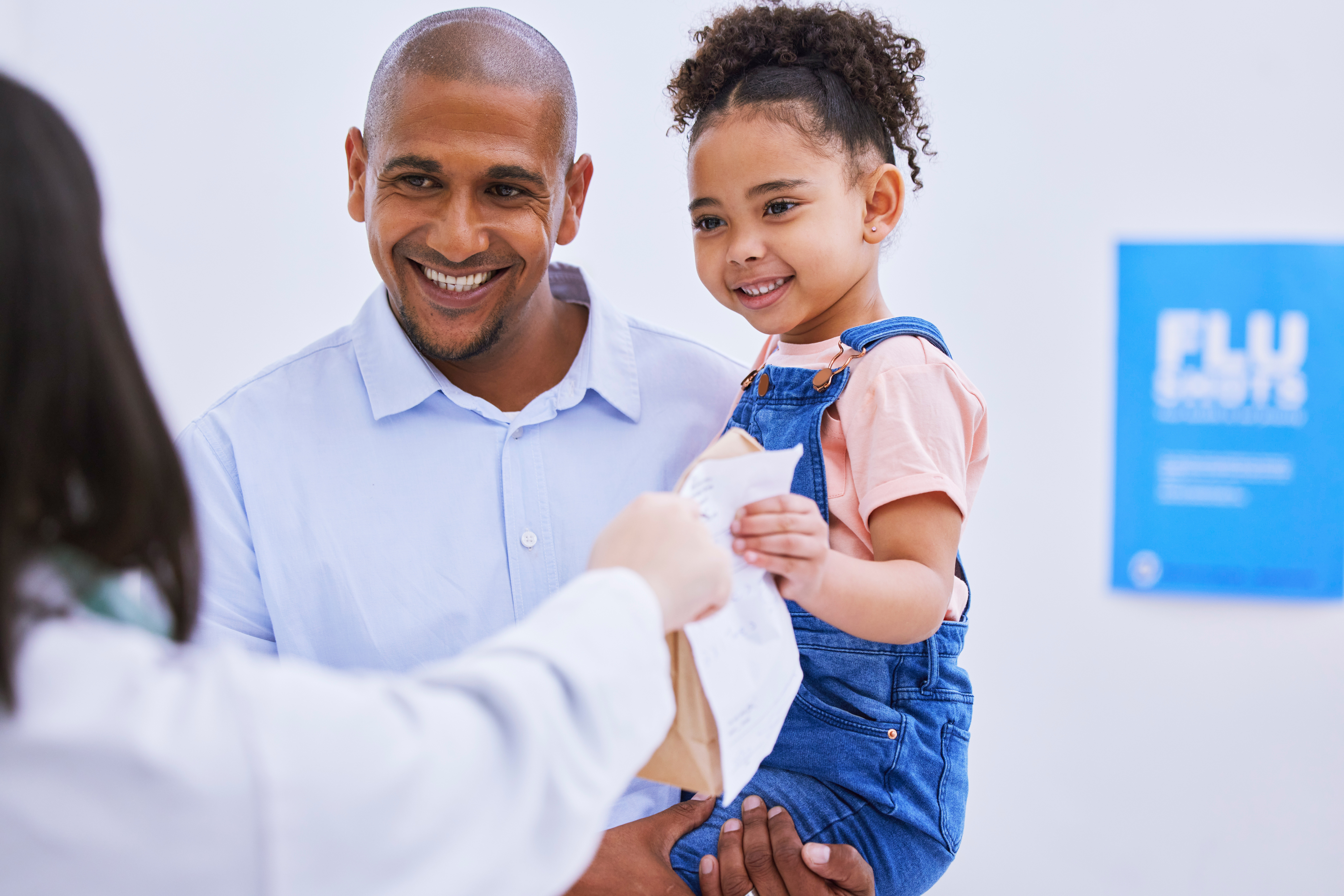 doctor showing clipboard to mother and children