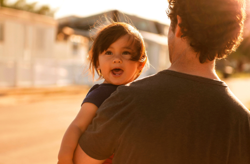 Father holding their toddler