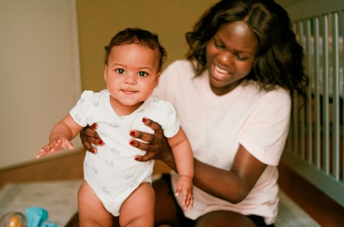 Mother holding her baby upright