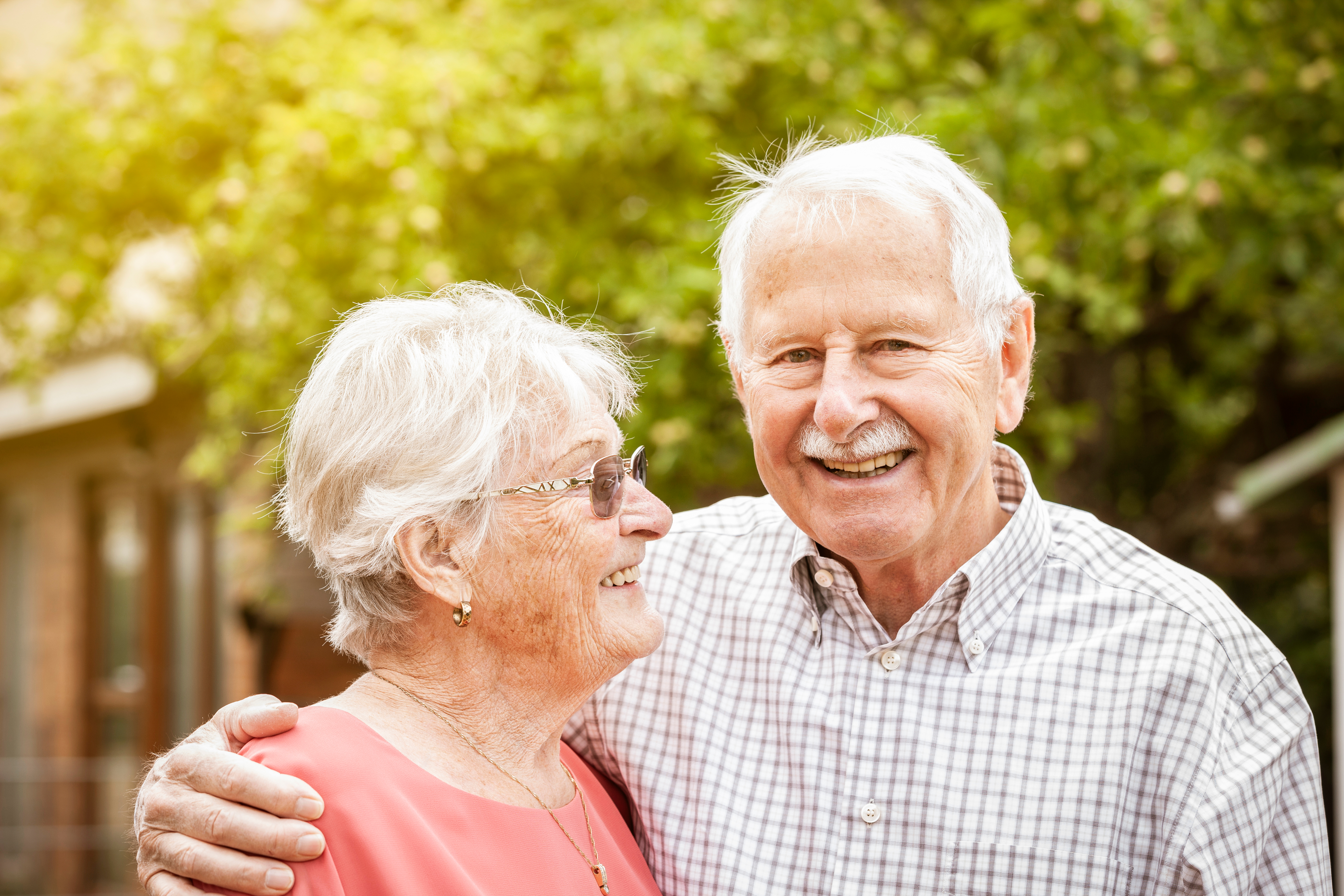 couple standing in front of home